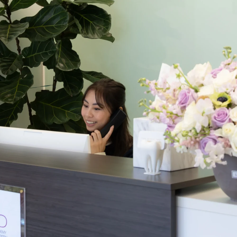 Receptionist Smiling At Front Desk